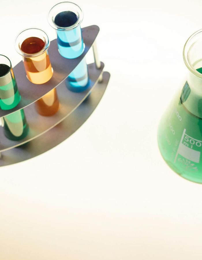Futuristic laboratory glass with glowing green liquid
